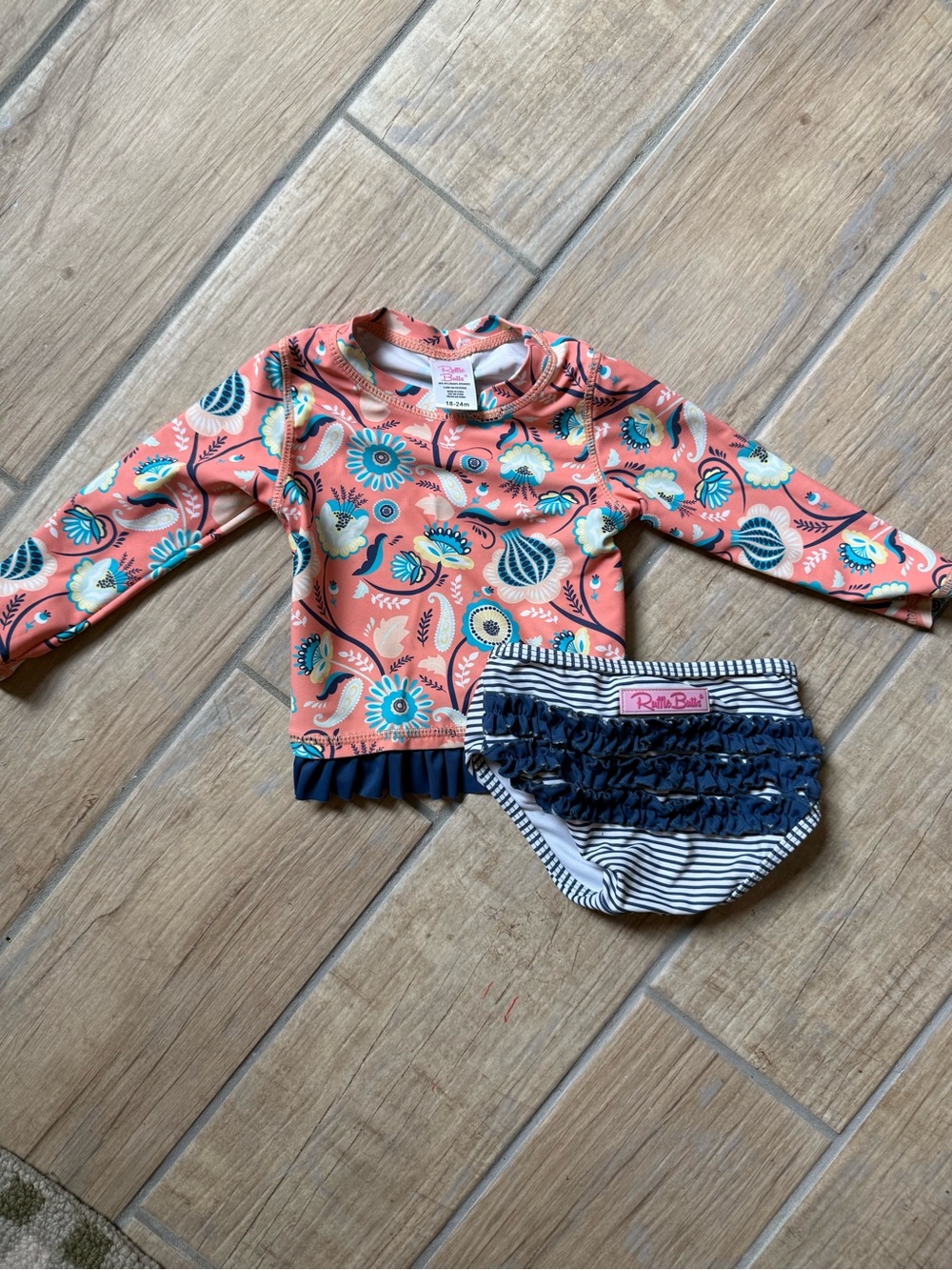 Ruffle Butts Coral Floral Rashguard with Navy Striped Ruffle Bottoms